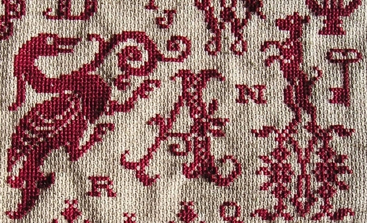 detail red cross stitch sampler